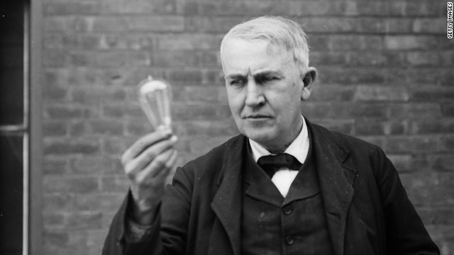 Edison holding vintage lightbulb outside